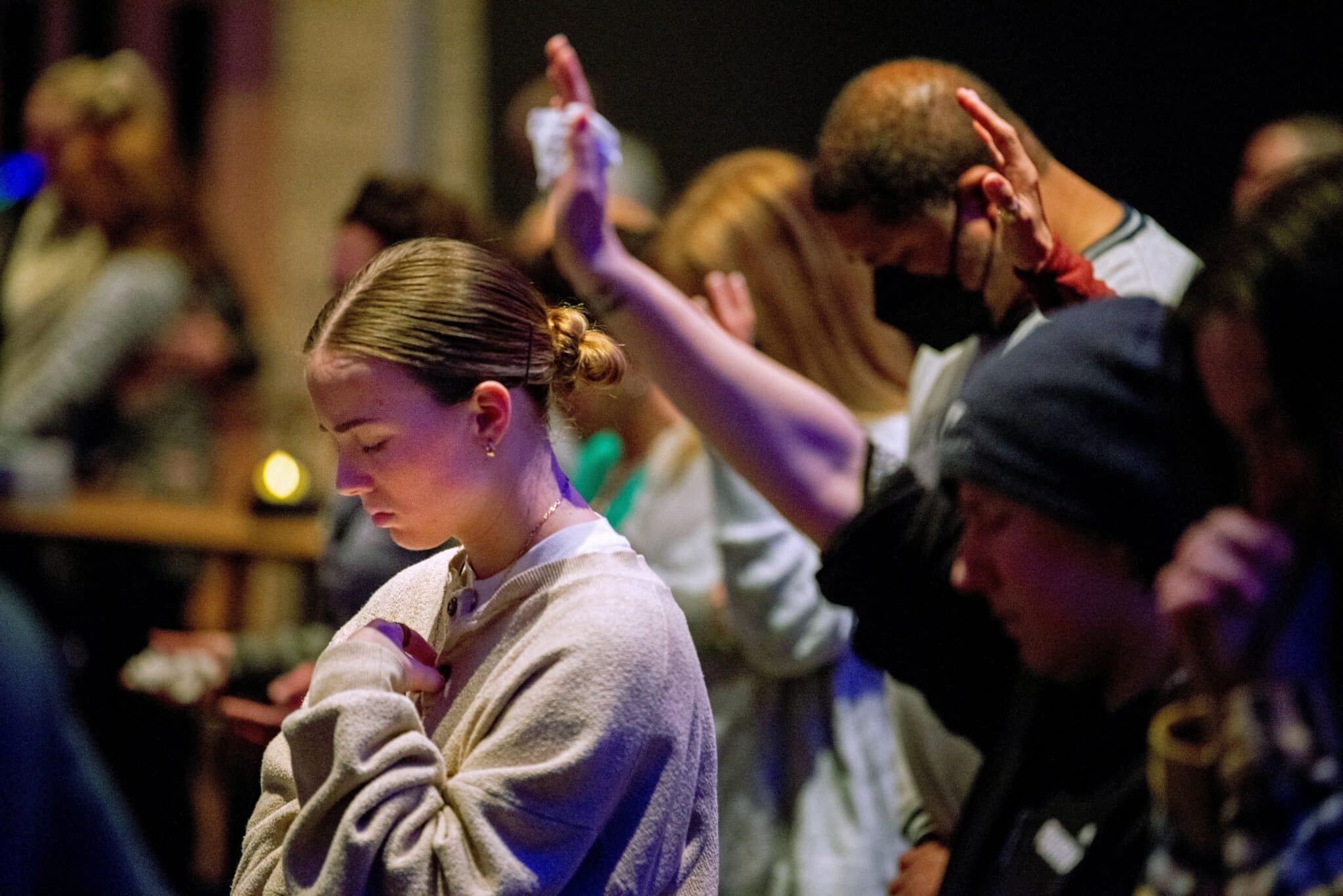 A young woman prays at Blackhawk Church in Madison, Wis., Dec. 16, 2024, as people gather to pray for victims and survivors of a mass shooting that day at Abundant Life Christian School in Madison. At least three people are dead, including the suspect, and others are injured, after the mass shooting, police said. (OSV News photo/Cullen Granzen, Reuters)