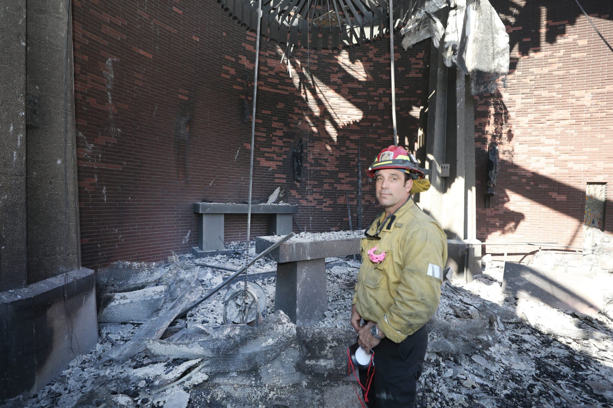 Capt. Bryan Nassour of the Los Angeles Fire Department poses inside the destroyed Corpus Christi Church in Pacific Palisades on the west side of Los Angeles Jan. 15, 2025, in the aftermath of the wildfires.