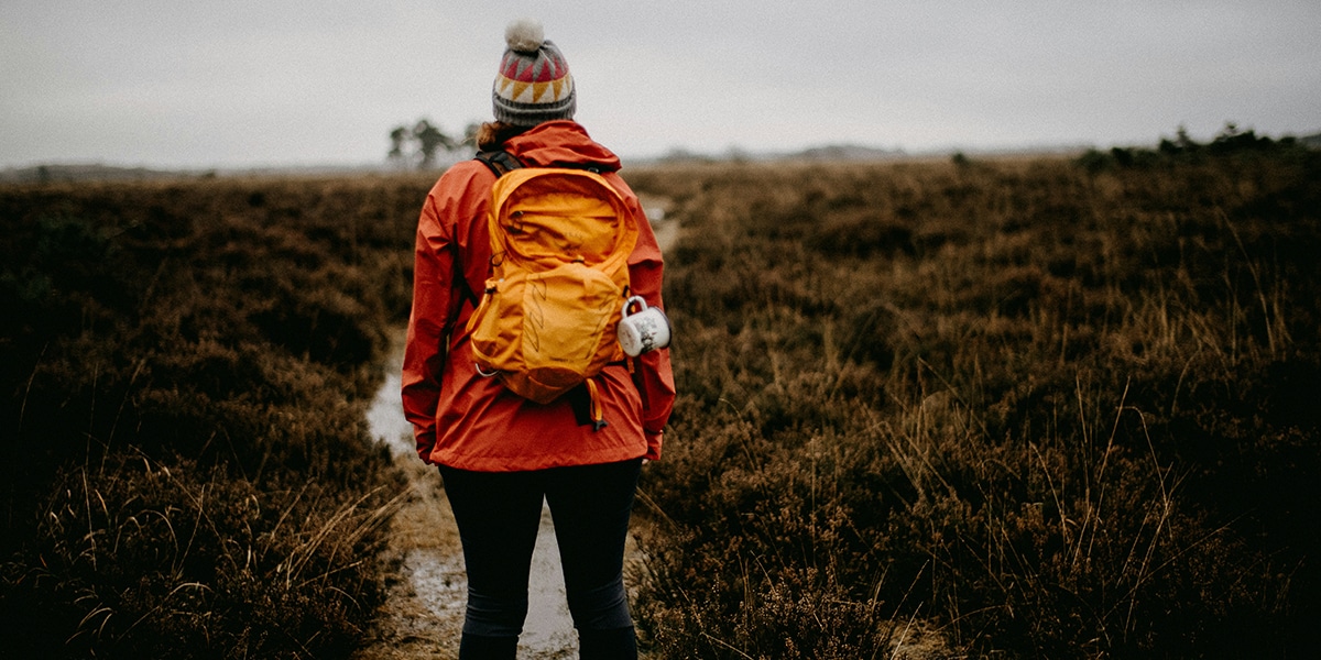 female hiker on a narrow path