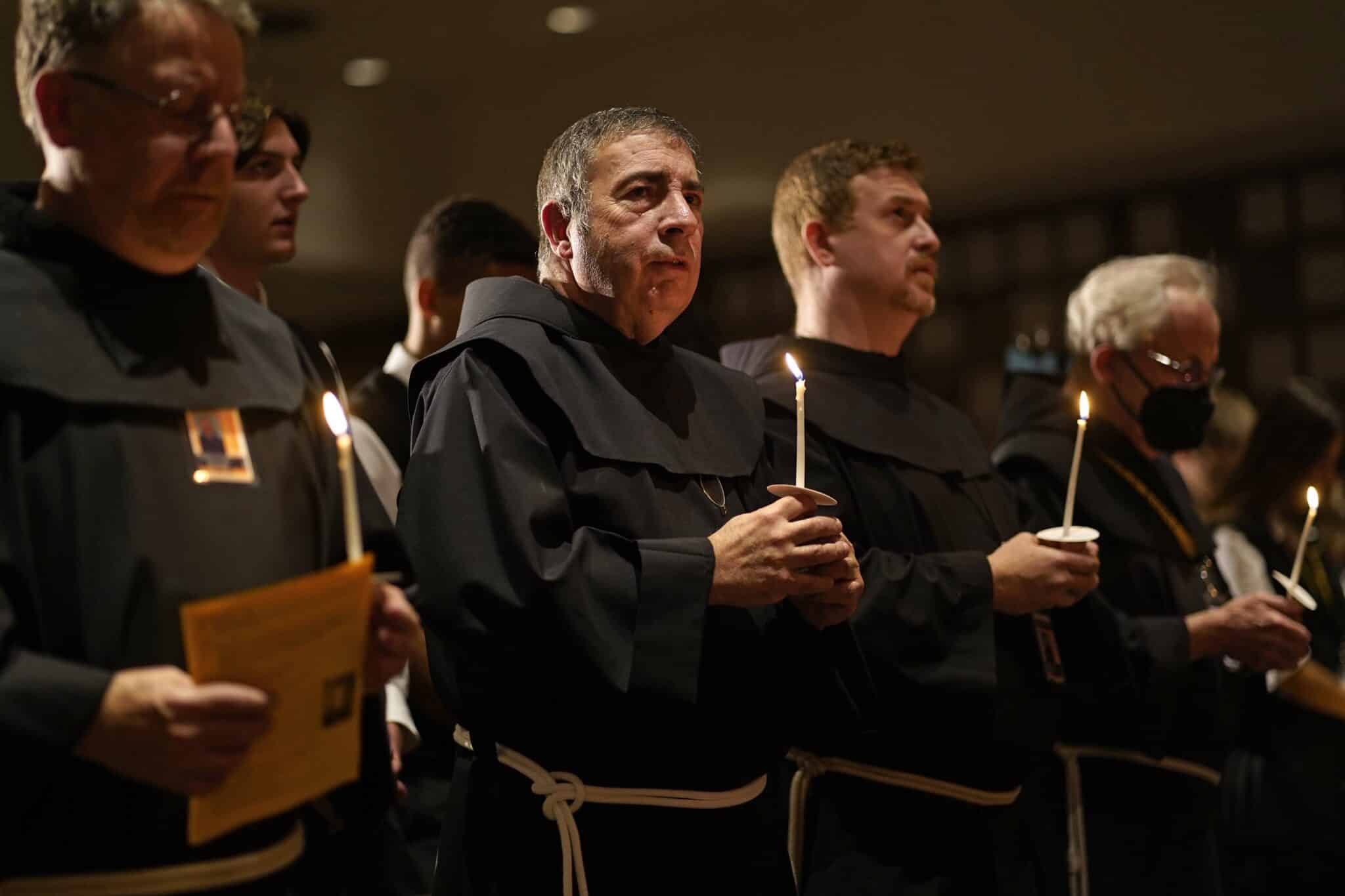 Members of the Franciscan Brothers of Brooklyn, N.Y., hold candles during a Mass marking the feast of St. Francis of Assisi at Franciscan-run St. Anthony's High School in South Huntington, N.Y., Oct. 4, 2022. The friars renewed their vows to consecrated ministry during the liturgy. (CNS photo/Gregory A. Shemitz)