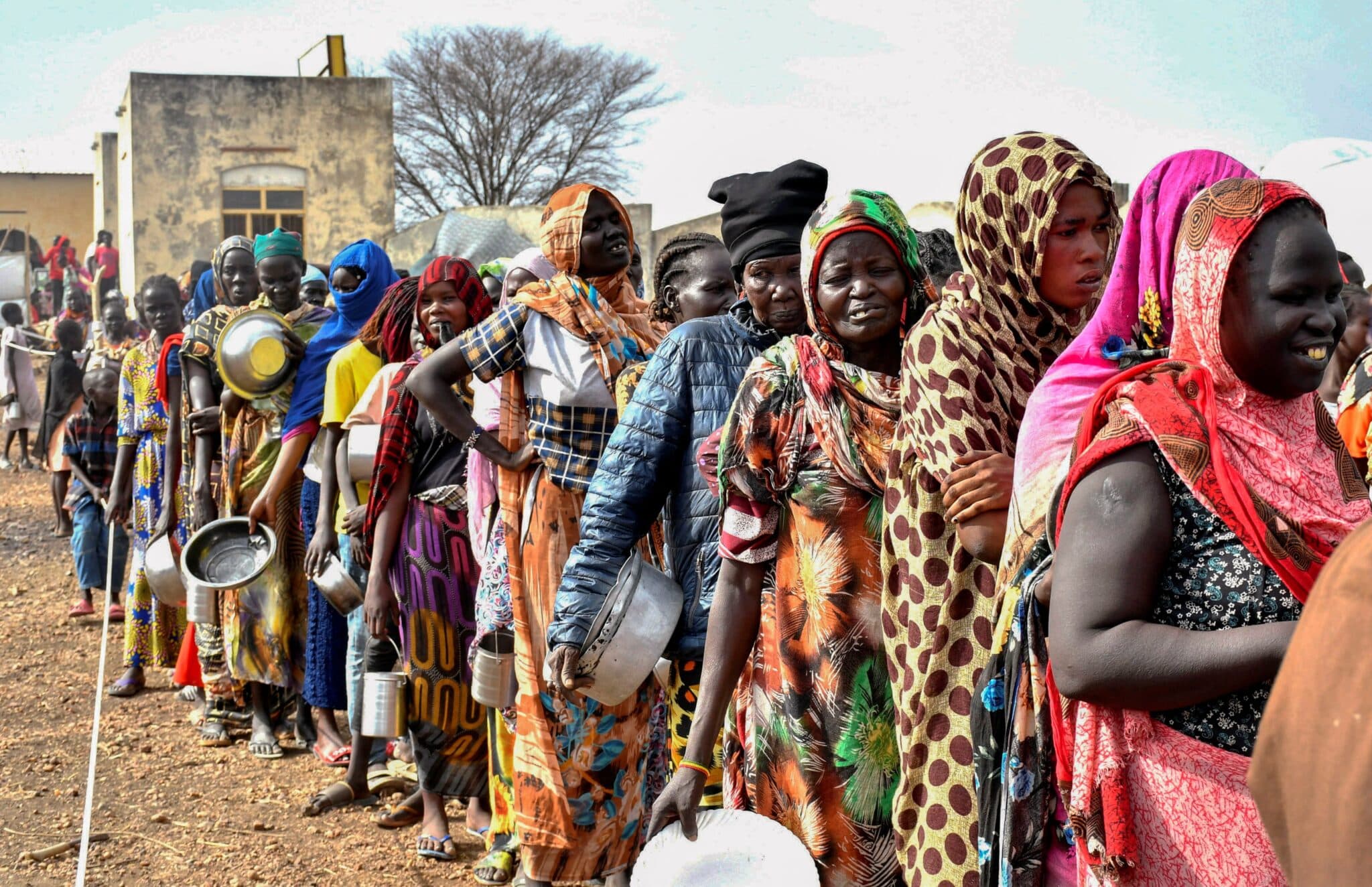 Women who fled the war-torn Sudan following the outbreak of fighting between the Sudanese army and the paramilitary Rapid Support Forces wait in line May 1, 2023, to receive food rations at the United Nations High Commissioner for Refugees transit center in in Renk, South Sudan. (OSV News photo/Jok Solomun, Reuters)