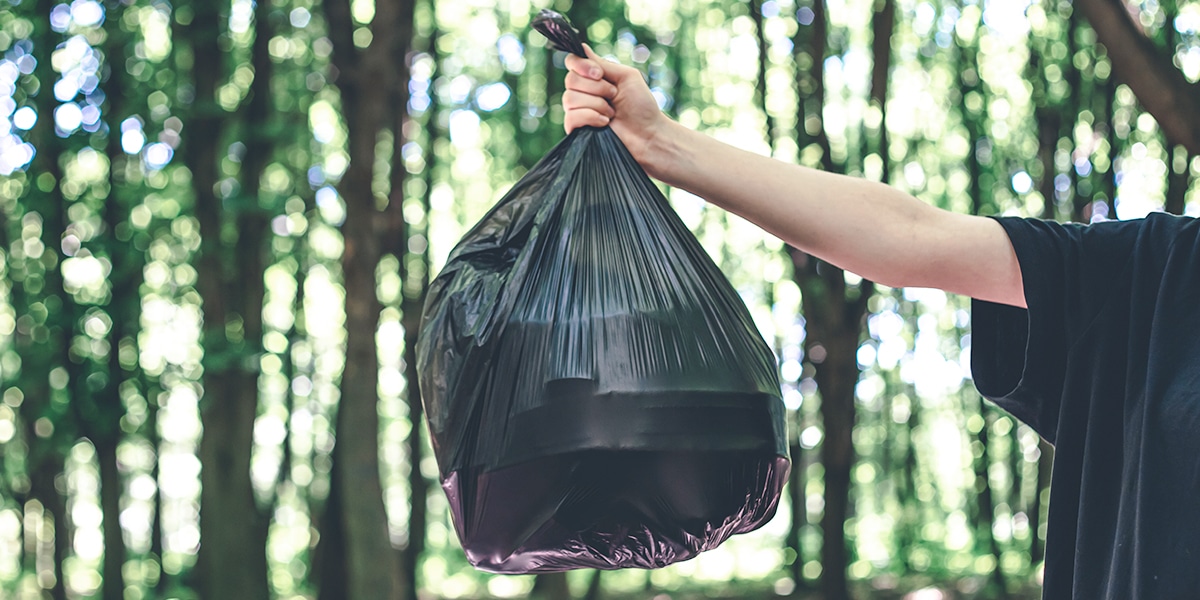 hand holding a plastic bag with stuff in it