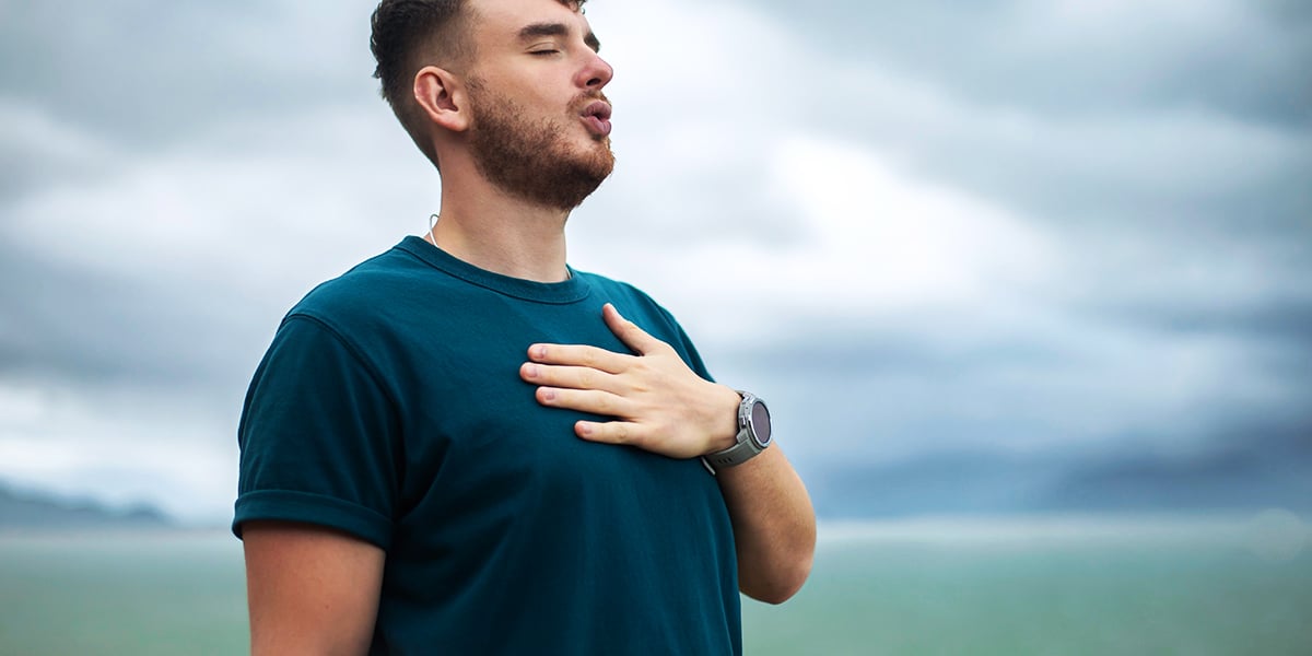 man taking a deep breath