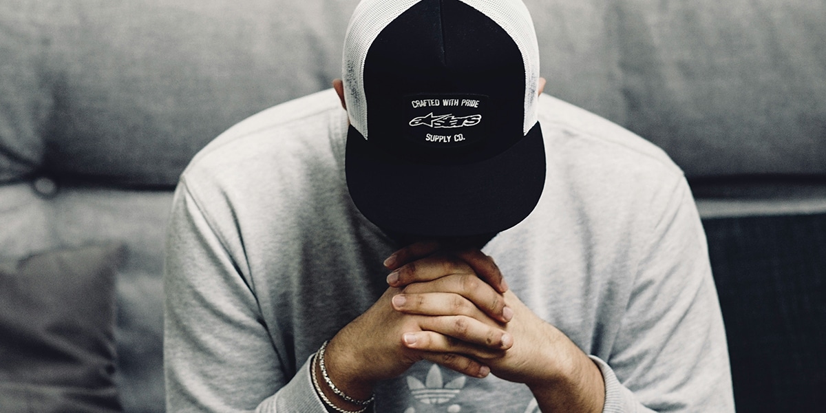 man praying with folded hands