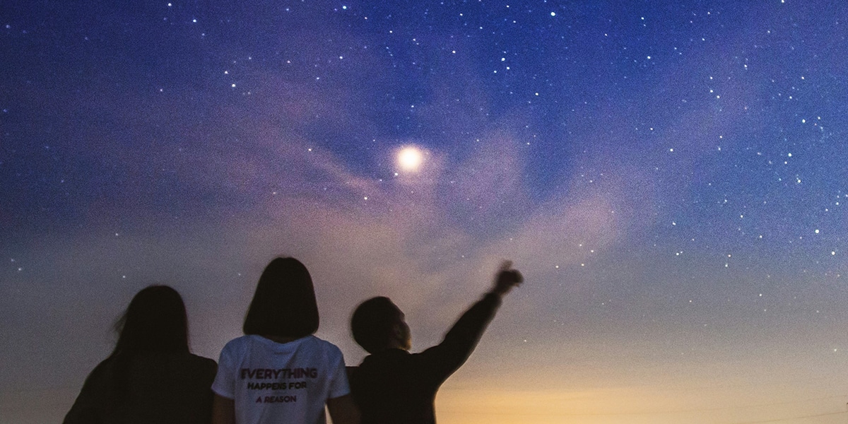 three young people star gazing