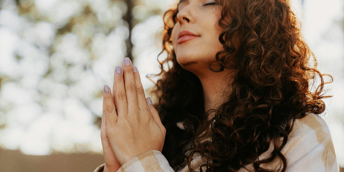 woman has her eyes closed in meditation