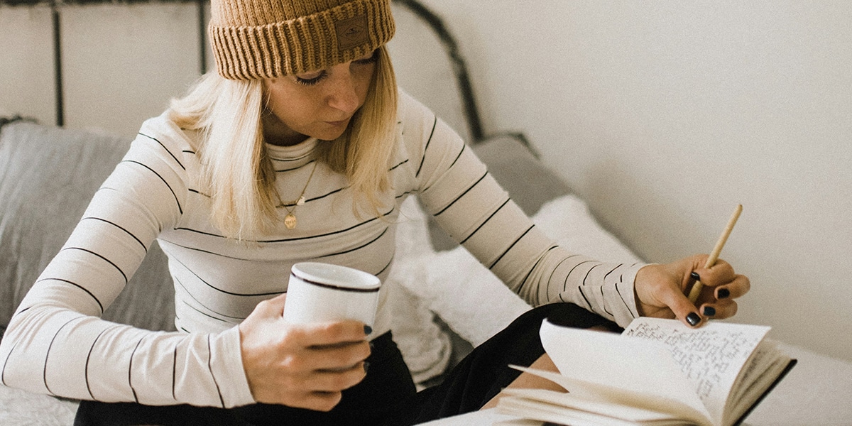 woman writing into a journal