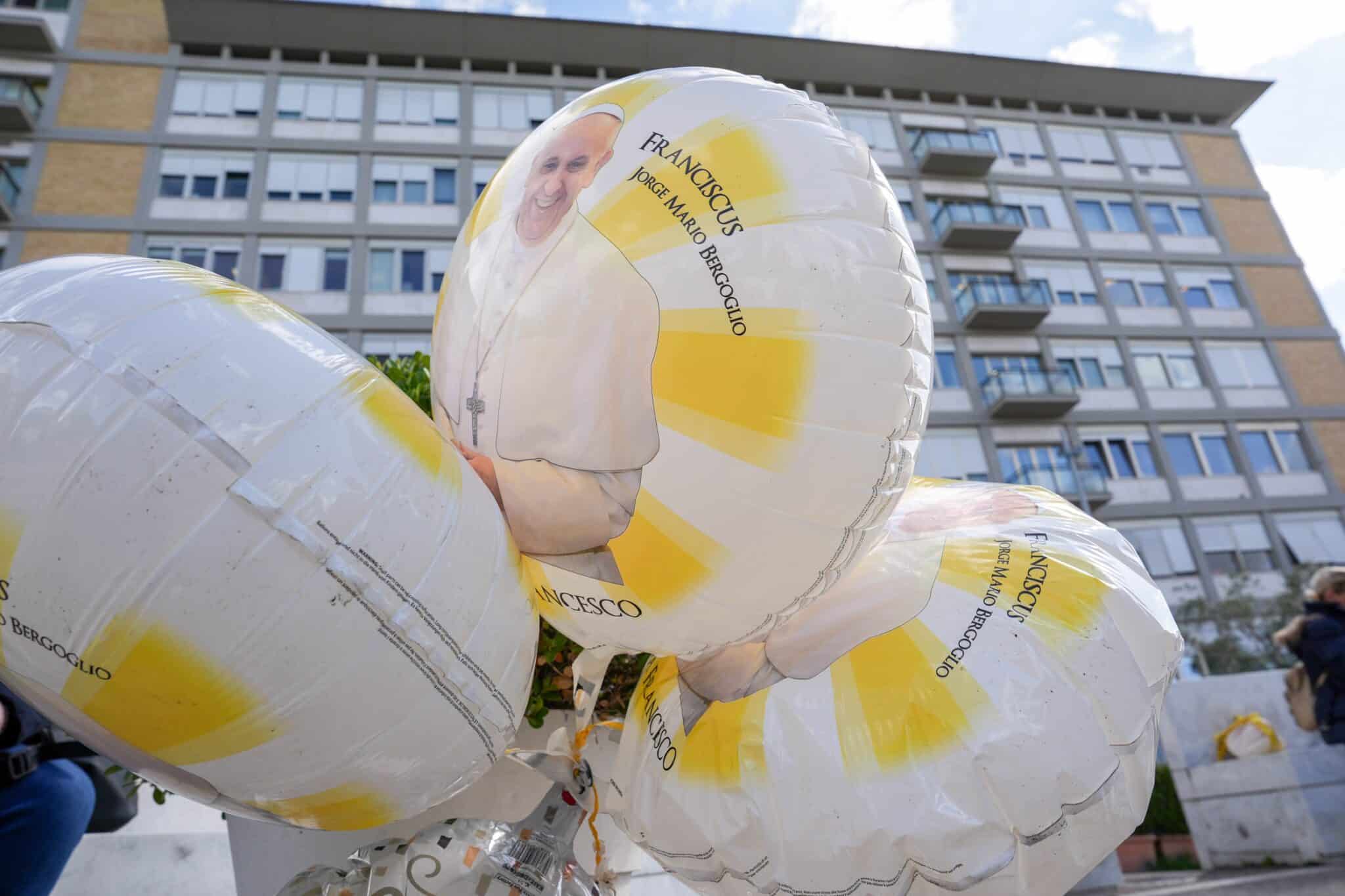 Balloons featuring an image of Pope Francis are seen outside Rome’s Gemelli hospital Feb. 27, 2025, while the pope is being treated there for double pneumonia