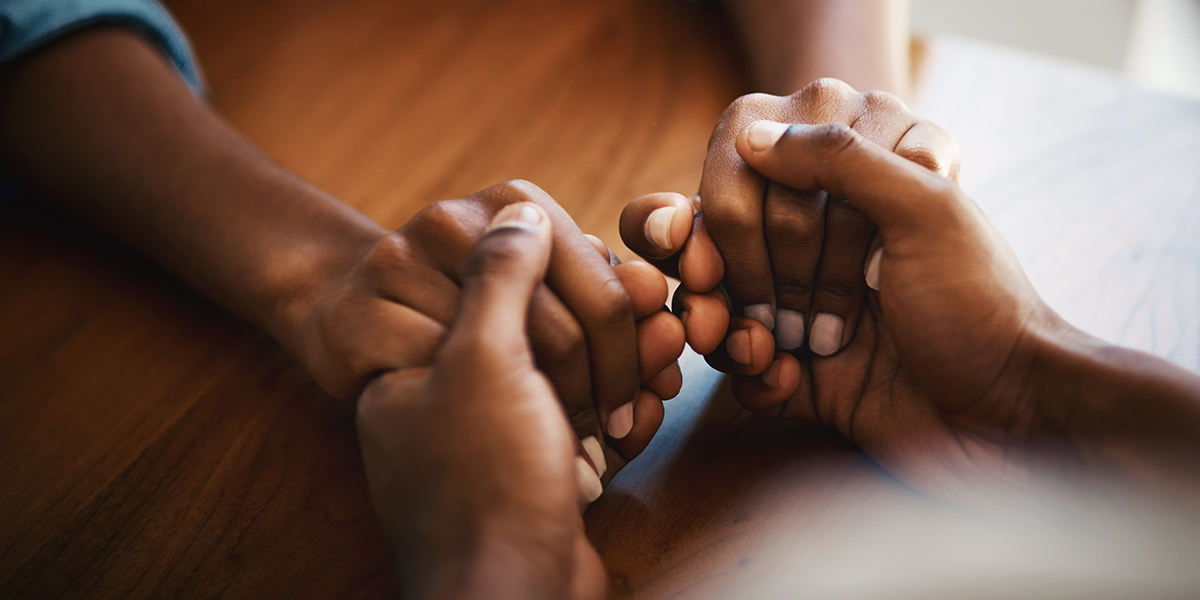 hand holding in gesture of forgiveness