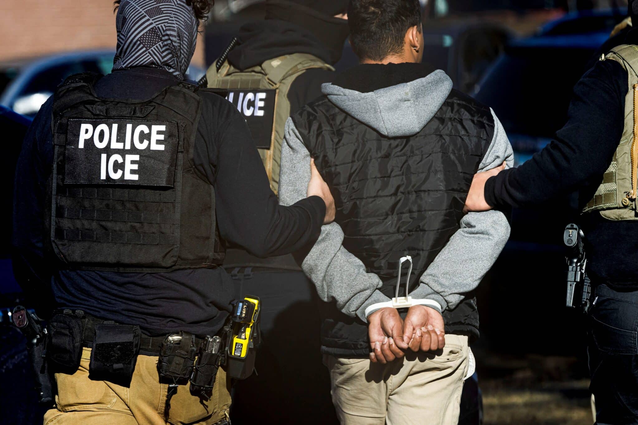 Agents with the Immigration and Customs Enforcement (ICE) detain a man after conducting a raid at the Cedar Run apartment complex in Denver Feb. 5, 2025.