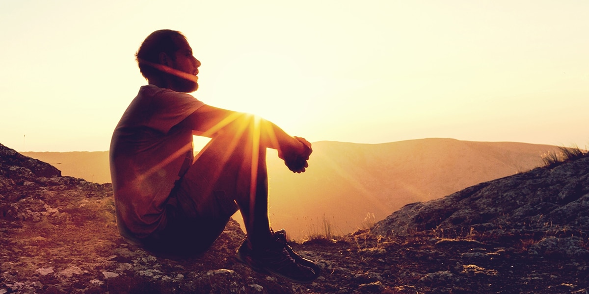 Man sitting and meditating on his past.