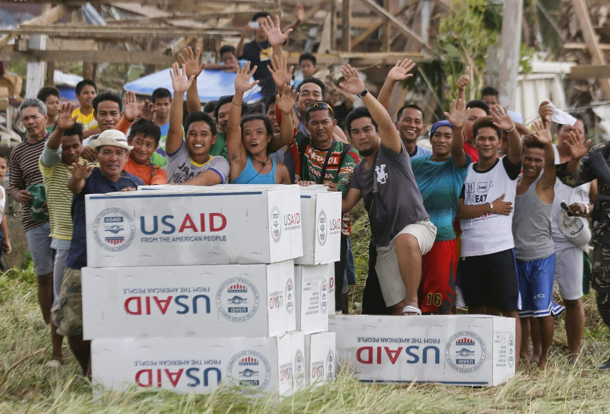 Filipinos are seen in a 2013 photo showing their gratitude and waving to the crew of a U.S. Navy aircraft after receiving aid from U.S. Agency for International Development (USAID) in the remote village of Guiuan, Philippines, after one of the most powerful typhoons ever recorded. The future of USAID has been called into question amid reports President Donald Trump had agreed to "shut down" the agency, which could have dramatic impacts on the poor and on the groups assisting them. (OSV News photo/Wolfgang Rattay, Reuters)