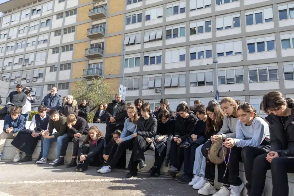 People pray outside Rome’s Gemelli hospital Feb. 23, 2025, where Pope Francis is being treated for double pneumonia. 