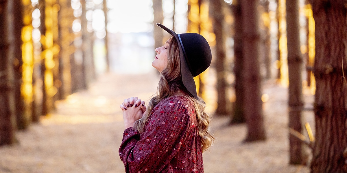 woman praying with a heart full of gratitude