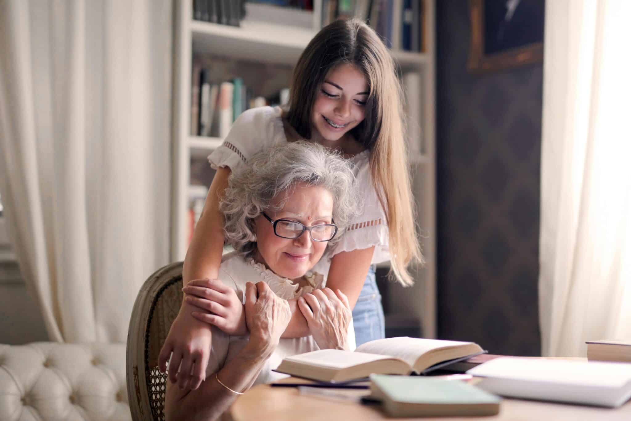 Grandmother and granddaughter reading | Photo by Andrea Piacquadio