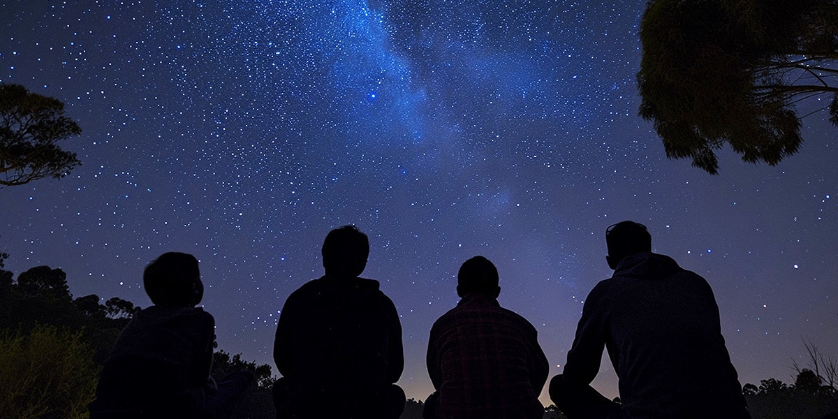 group of people stargazing in the night sky