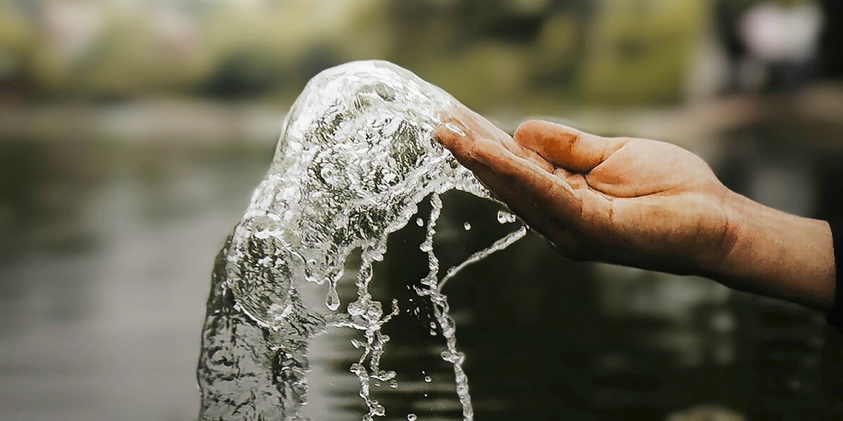 hand splashing water from a river