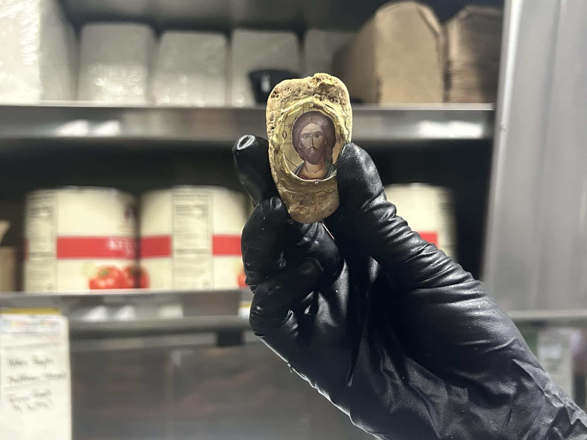 Larisa holds up the rock featuring Jesus' face that was found at the car wash where she worked, which she believes saved her job from burning down in the Palisades Fire in early January 2025. (OSV News photo/courtesy Kimmy Chacon)