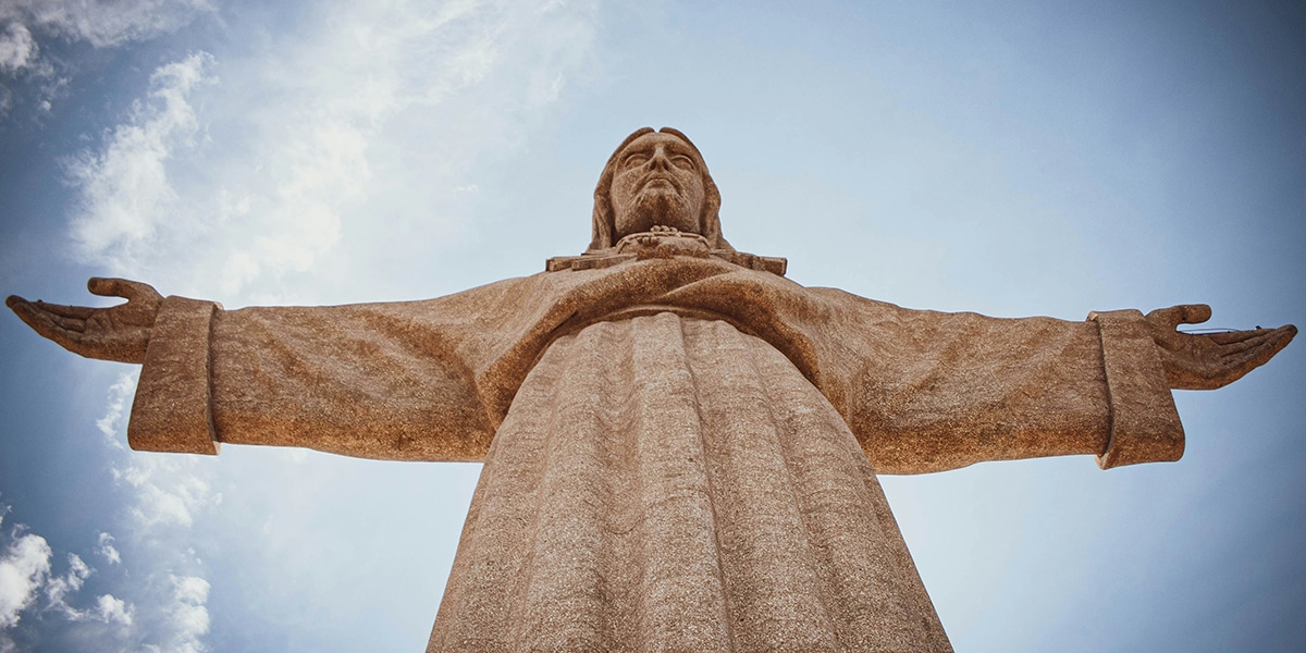 stone statue of Jesus with open arms