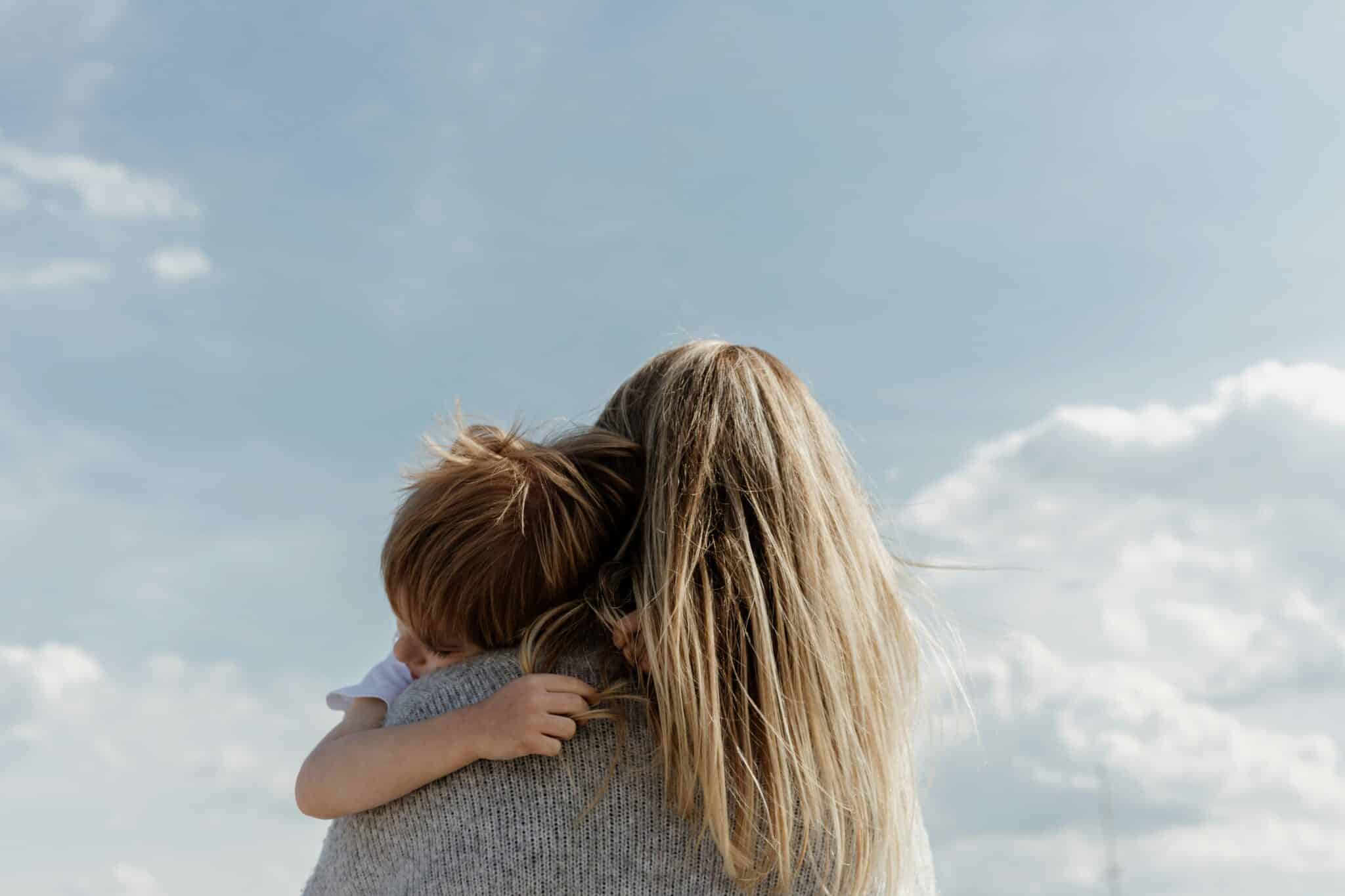 woman holding her son | Photo by Bethany Beck on Unsplash