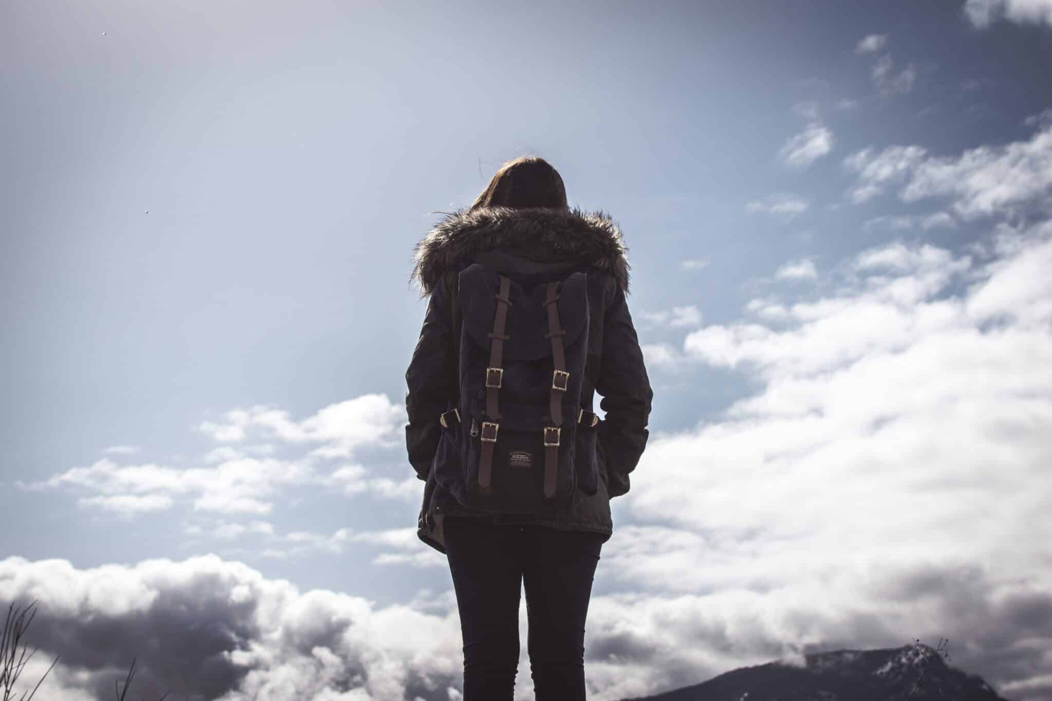 Woman looks at the sky | Photo by Jason Mavrommatis on Unsplash