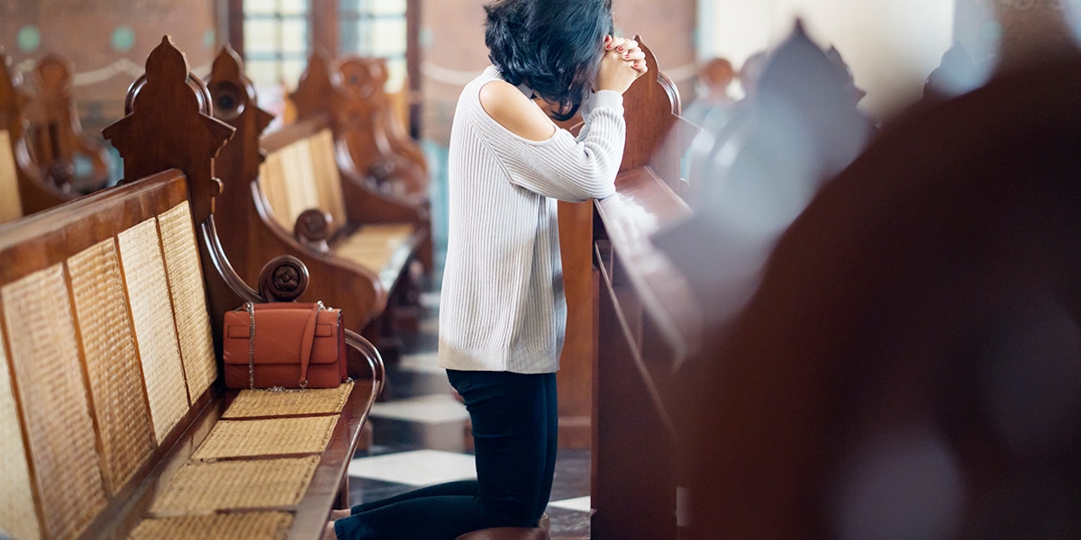 woman praying in church