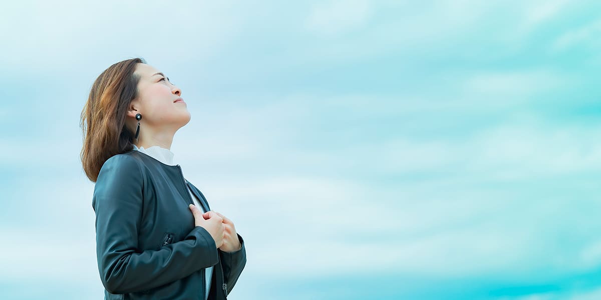 woman with a worried face looking up to heaven